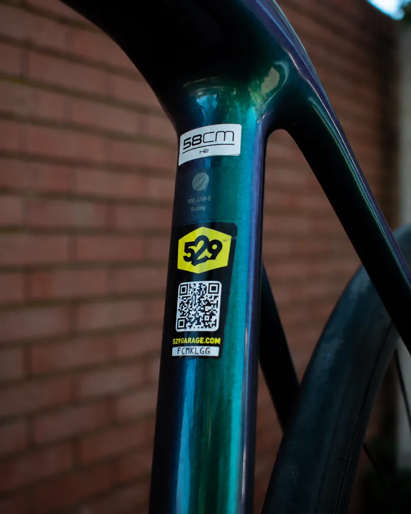 A 529 Shield on a bike frame, with its QR code and seven-character ID